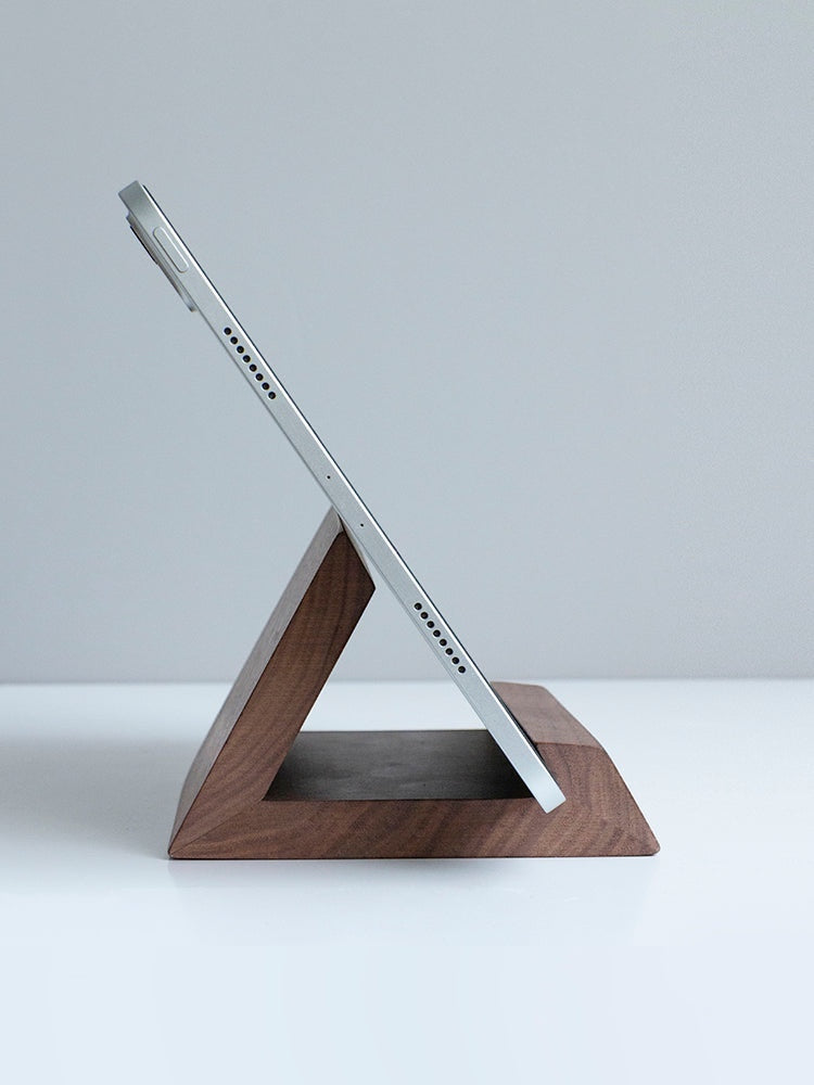 Belcrest modern wooden tablet stand in a geometric design, holding a silver tablet at an optimal viewing angle.