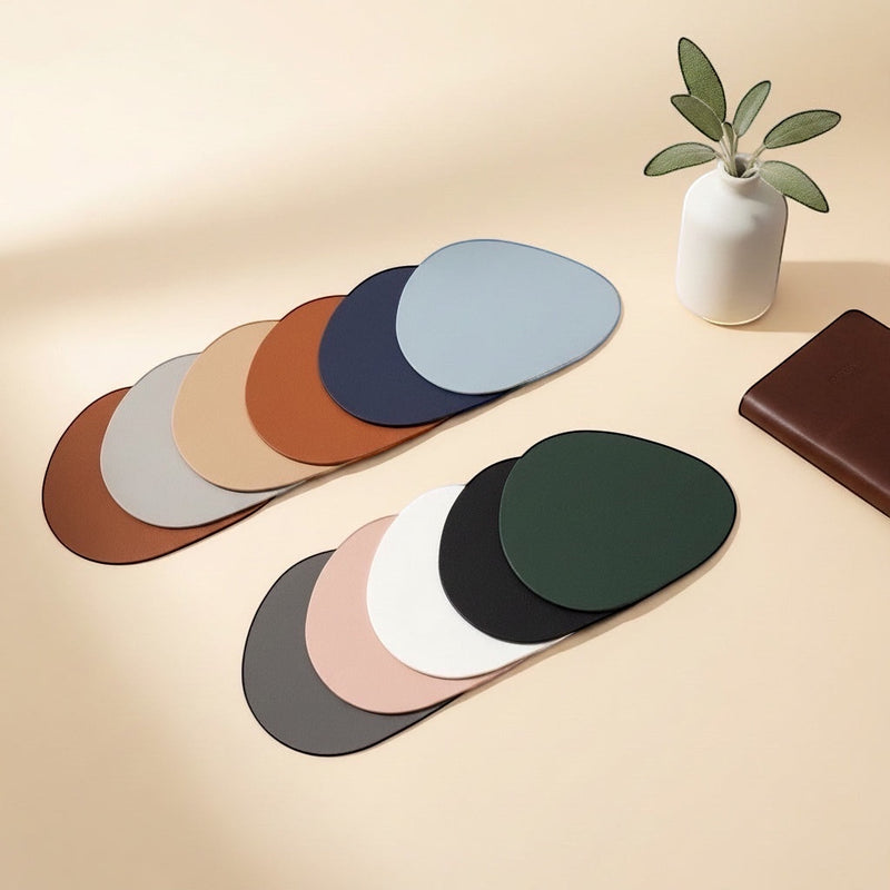 Belcrest modern abstract pebble-shaped table coasters in navy, grey, blush pink, black, terracotta, and burgundy.