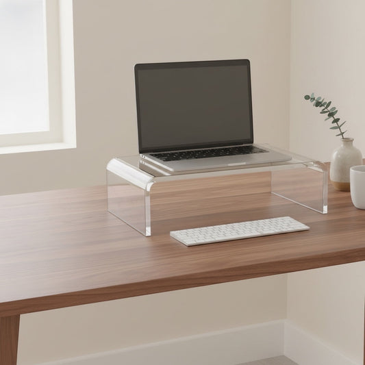 Belcrest clear acrylic monitor stand riser with a laptop and keyboard on a wooden desk.