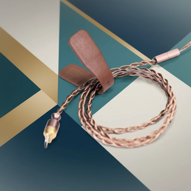 Belcrest brown genuine leather cable management clips holding braided headphone wires.