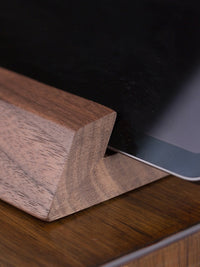 Belcrest modern wooden tablet stand in dark walnut with geometric design, holding a tablet at an optimal viewing angle.