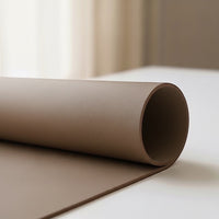 Belcrest reversible desk pad in taupe vegan leather, offering a smooth surface for work and cork for grip. Protects desk.