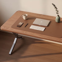 Belcrest reversible desk pad in brown vegan leather, featuring a laptop, keyboard, phone, and mug. Protects desk.
