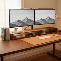 Belcrest screen bar lamp mounted on dual monitors, providing glare-free workspace lighting. Brushed aluminum finish.