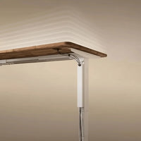 Belcrest adjustable standing desk cable management system in white aluminum alloy, keeping cables tidy.