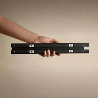 Belcrest white aluminum standing desk cable management system with magnetic clips.